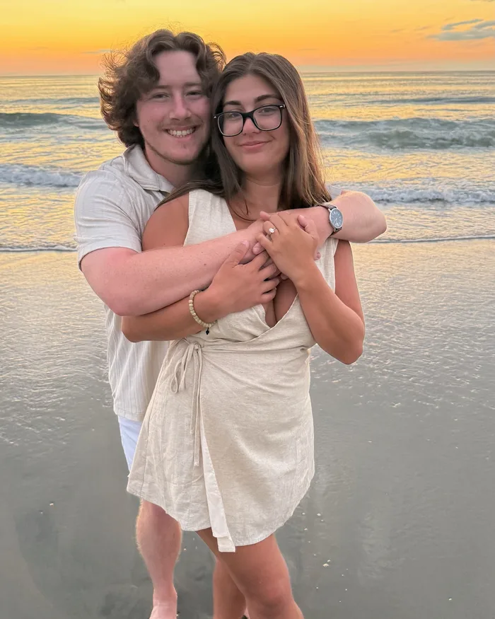 Isabella and Johnny embracing at sunset